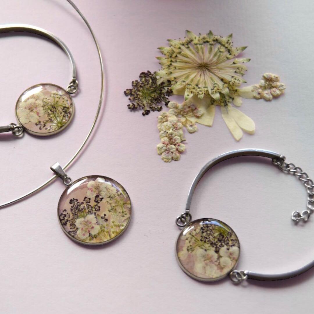 Pressed wedding flowers made into a resin pendant and bracelet