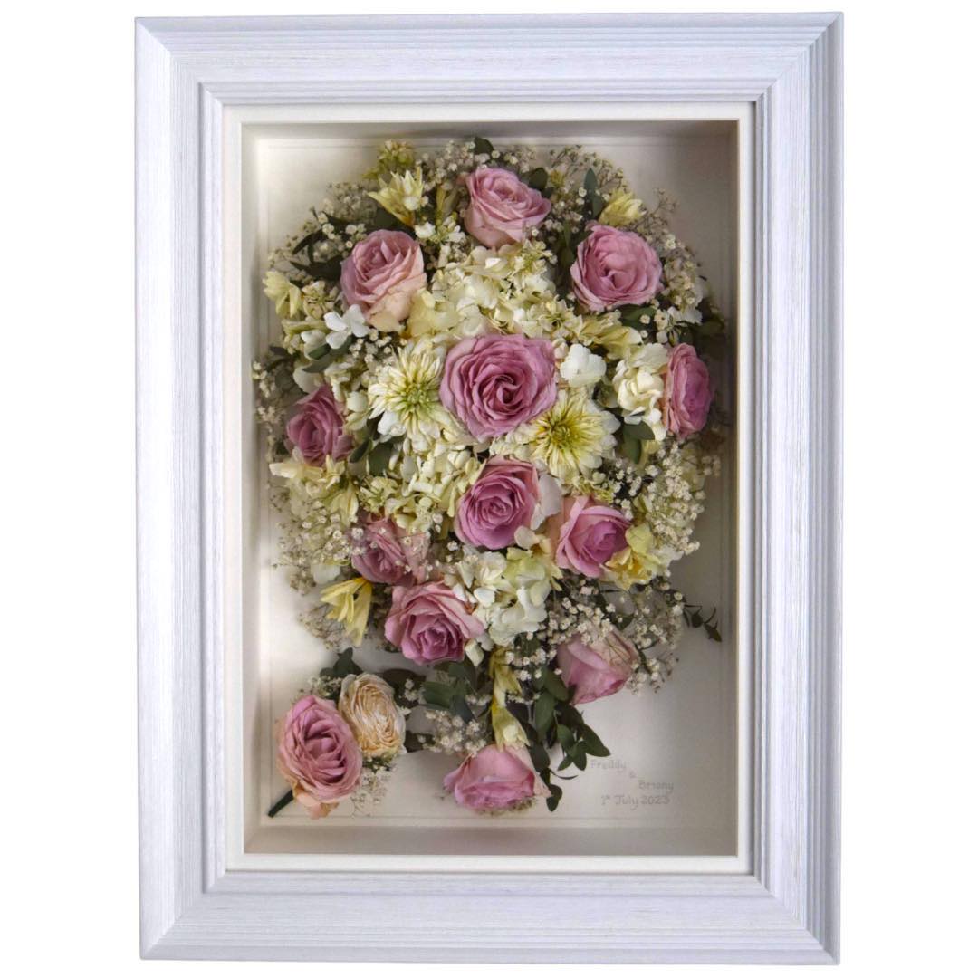 Pink rose and white Dahila preserved bridal bouquet in a white frame