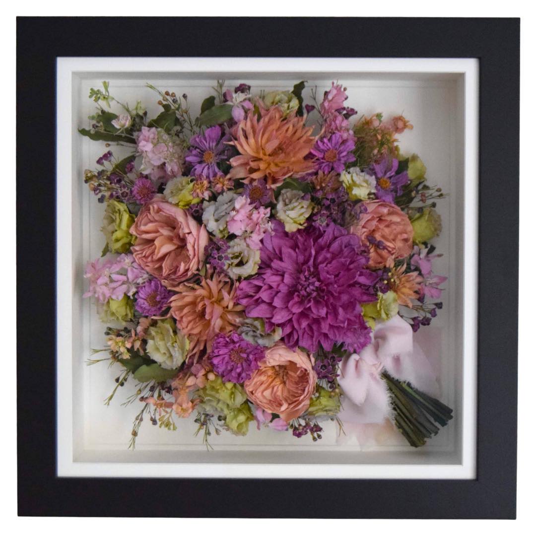 Bright Dahlia and Rose handtied preserved bridal bouquet displayed in a black frame