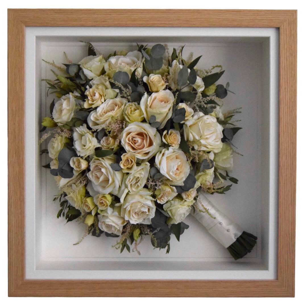 White and green mixed preserved bridal bouquet in an oak frame