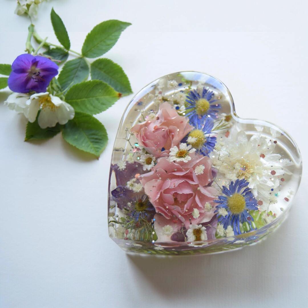 Remembrance flowers preserved and embedded in a resin heart
