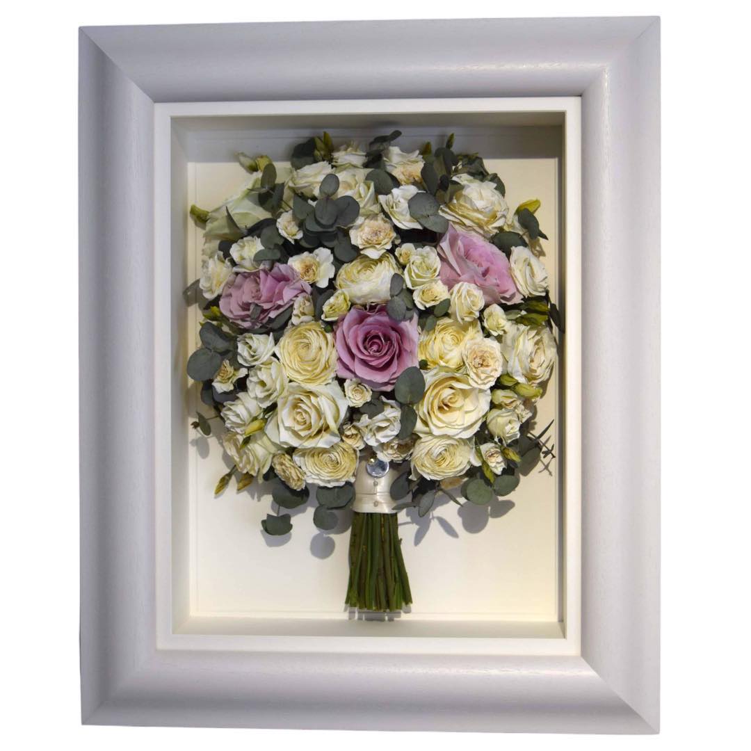 Framed and preserved hand tied bridal bouquet on white frame