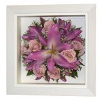 Preserved remembrance pink lilies and roses displayed in a white box frame