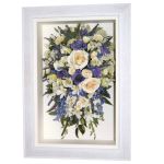 Preserved shower bridal bouquet with white roses and assorted purple flowers in a white box frame