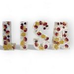 Silk bridal cake flowers in resin name letters