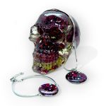 Preserved burgundy roses embedded in resin skull and matching rose petals in stainless steel resin bracelet and pendent